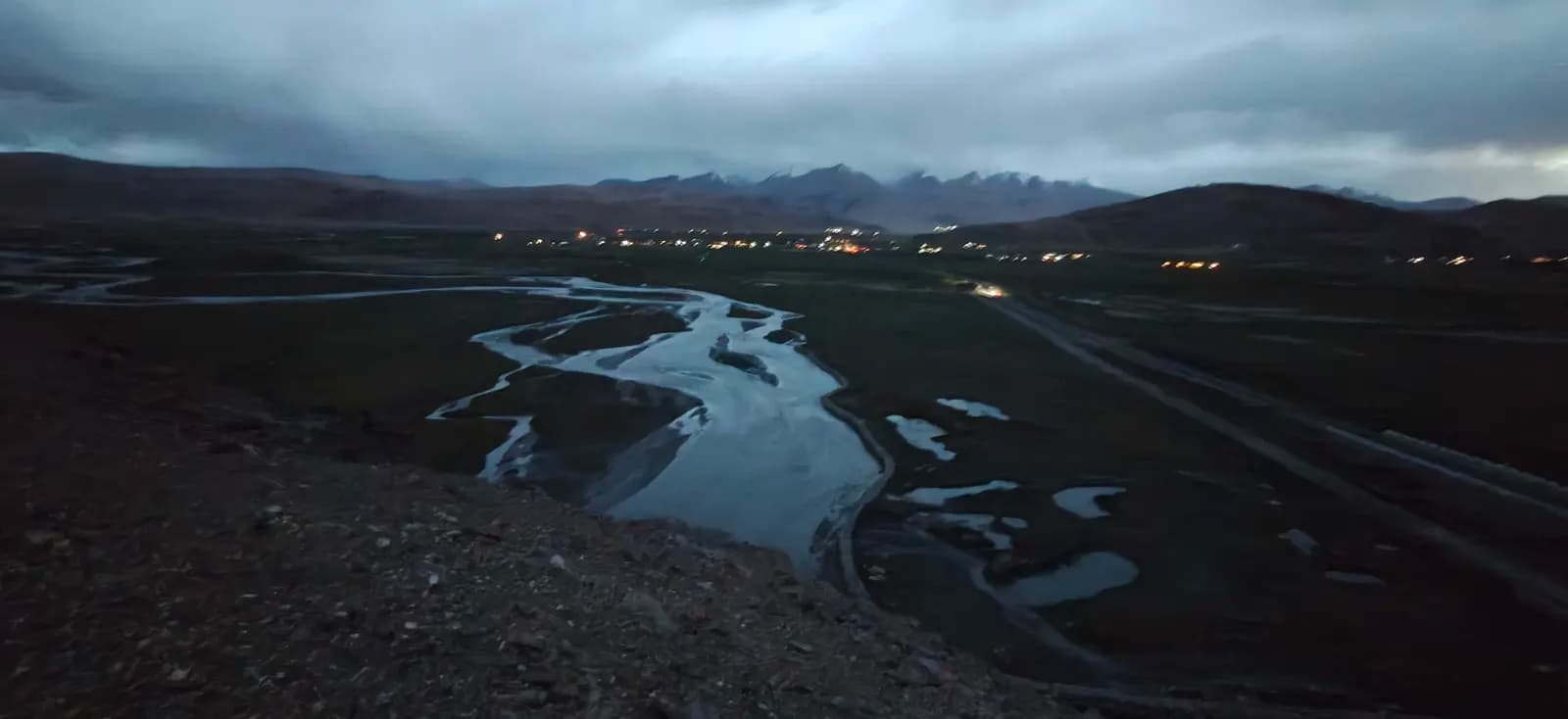Village lights and river channels at dusk